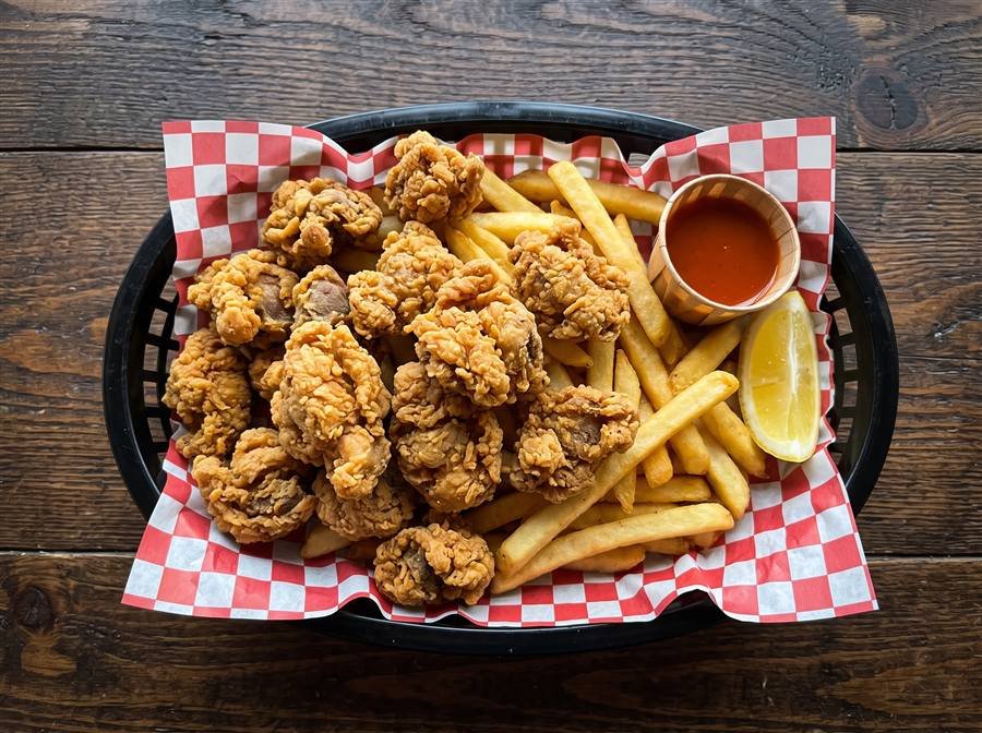 Fried chicken gizzards basket with fries and cocktail sauce